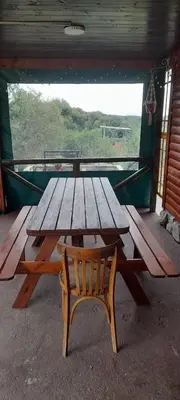 a wooden picnic table and a bench in a room at La Lugarda in Cuesta Blanca