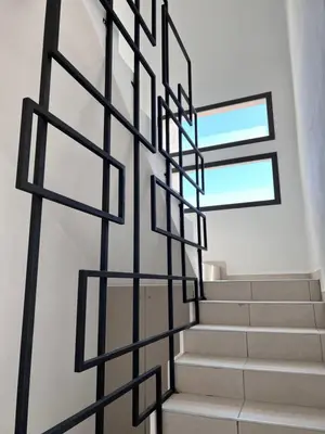 a staircase in a house with black metal railings at Terra Bella in San Antonio de Arredondo