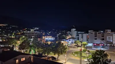 a city lit up at night with buildings and trees at Terraza Terraza in Villa Carlos Paz