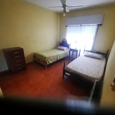 a bedroom with two beds and a dresser and a window at La Jose in Santa María