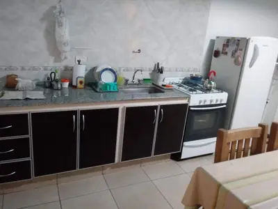 a kitchen with a sink and a stove and a refrigerator at Carlos paz tower in Villa Carlos Paz