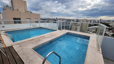 a swimming pool on the roof of a building at Viamonte deluxe Barrio General Paz 2 dormitorios in Cordoba
