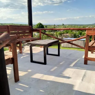 a wooden bench sitting on top of a roof at Nápoles in Santa Rosa de Calamuchita