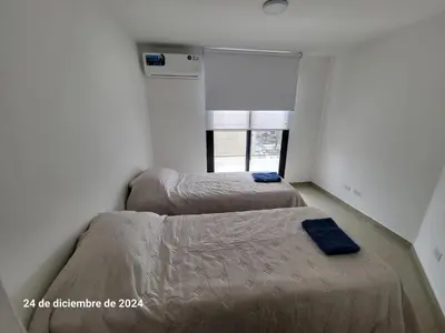 two beds in a room with a window at plaza Colonn in Cordoba