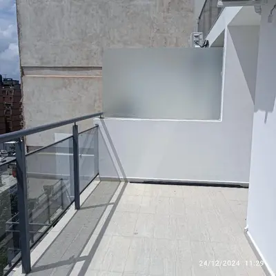 a white refrigerator sitting on top of a balcony at plaza Colonn in Cordoba