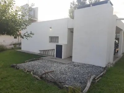 a white building with a door on the side of it at Casa Emilia Tanti in Tanti