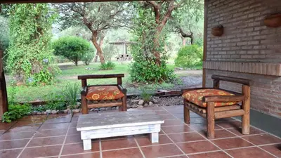two chairs and a bench on a patio at soy ahora in Pueblito