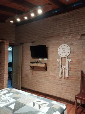 a room with a brick wall with a clock on it at soy ahora in Pueblito