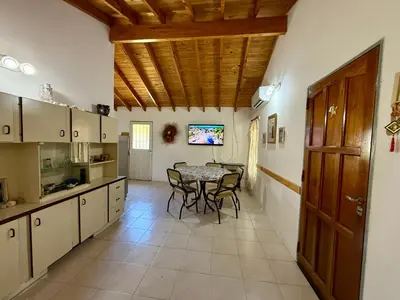 a kitchen and dining room with a table and chairs at Mina Clavero Chalet in Mina Clavero