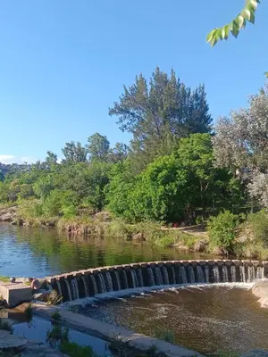 a river with a waterfall in the middle at Departamento frente al rio solo familias in Villa Carlos Paz