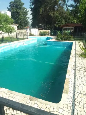 an empty swimming pool with blue water at Portal de las sierras in Bialet Massé