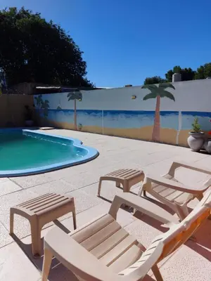a group of lounge chairs and a swimming pool at Cabañas los materos 2 in Cordoba