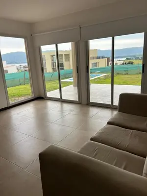 a living room with a couch and sliding glass doors at Puerto del Águila home in La Estancia
