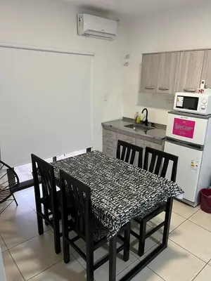a kitchen with a table and chairs in a kitchen at Terra Bella Hidromasajes in San Antonio de Arredondo