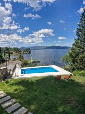 a swimming pool with a view of the water at Hermosa Casa en Villa del Lago Carlos Paz Vista al lago, zona exclusiva y residencial in Cordoba