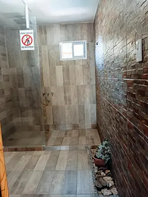 a bathroom with a shower and a sign that says no smoking at La Cautivadora Potrero de Garay in Potrero de Garay