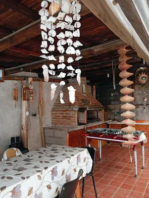 a dining room with a table and a chandelier at La Cautivadora Potrero de Garay in Potrero de Garay