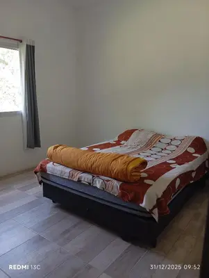 a bed with a blanket on top of it in a room at La Cautivadora Potrero de Garay in Potrero de Garay