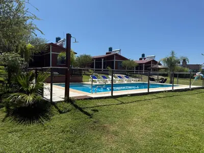 a house with a swimming pool in a yard at Cabañas AdamiS 5 in Villa Cura Brochero