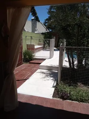a fenced in yard with a fence and a house at Complejo La Tere- depto 2 in Cordoba