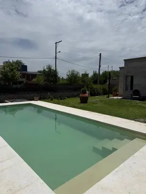 a large empty swimming pool in a yard at SuiteMilSueños in Arroyo de Los Patos