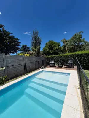 a swimming pool with blue water in a yard at Don EDELMI 2 in Cordoba