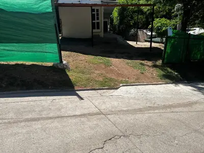 a house with a green covering on the side of a street at Monarcas II in Villa Carlos Paz