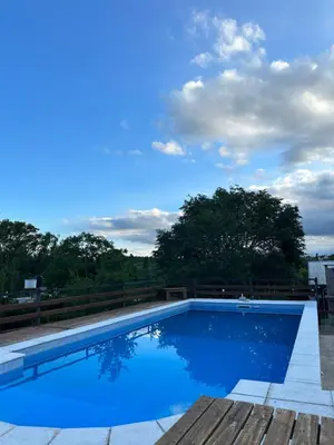 a swimming pool on a roof with a blue sky at Cabañas las marias 3 in Tanti Nuevo