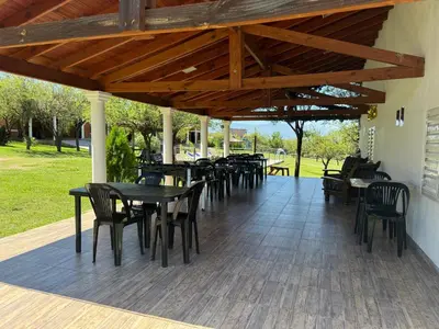 a group of tables and chairs on a patio at Cabañas AdamiS 2 in Villa Cura Brochero