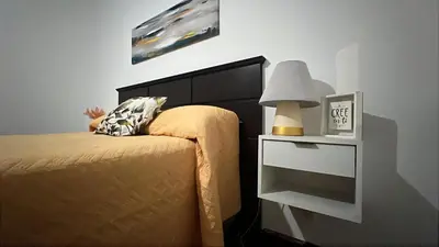 a bedroom with a bed and a nightstand with a lamp at CENTRO CORDOBA departamento 2 dormitorios in Cordoba