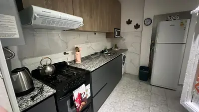a small kitchen with a stove and a refrigerator at CENTRO CORDOBA departamento 2 dormitorios in Cordoba