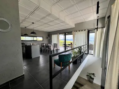 a living room with a kitchen and a dining room at El Descanso in San Roque