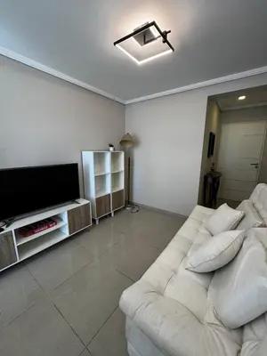 a living room with a white couch and a flat screen tv at Beautiful apartment in Cordoba
