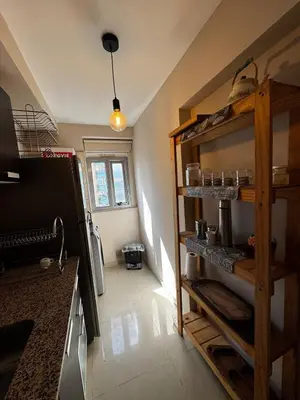 a kitchen with wooden shelves in a room at Beautiful apartment in Cordoba