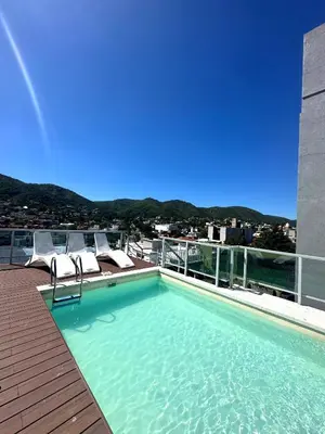 a swimming pool on the roof of a building at Depto Nuevo en el Centro, Cochera, Pile, Aire Ac in Villa Carlos Paz