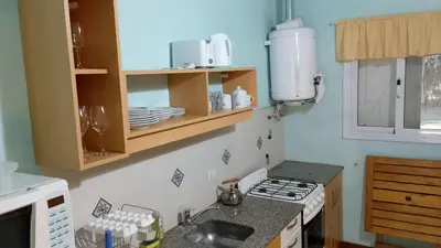 a small kitchen with a stove and a sink at Las Icarias Casas de campo in Las Calles
