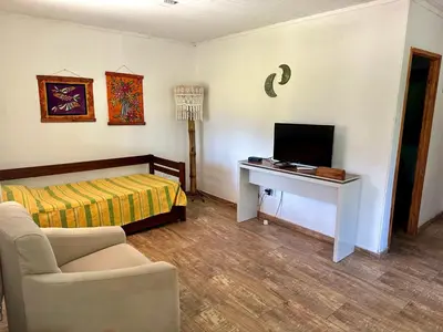 a living room with a bed and a television at Cabañas Enki in La Paz