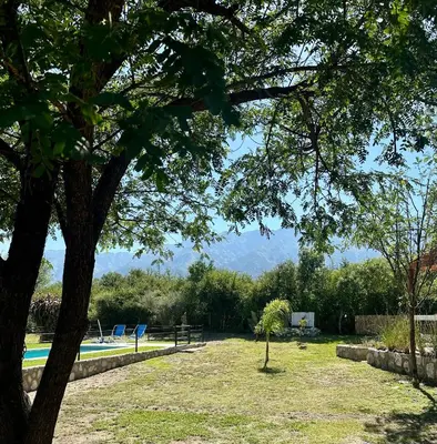 a yard with a picnic table and a swimming pool at Cabañas Enki in La Ramada