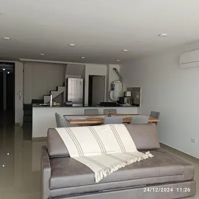 a living room with a couch and a kitchen at plazaColon in Cordoba