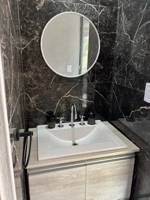 a bathroom with a sink and a mirror at El Paisaje in Villa Parque Siquiman