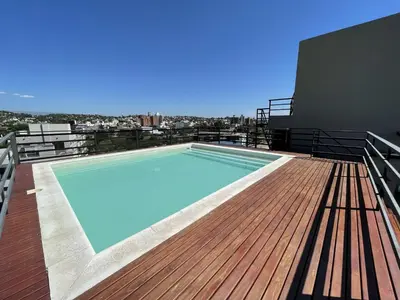 a swimming pool on the roof of a building at Departamentos Céntricos Exclusivos in Villa Carlos Paz