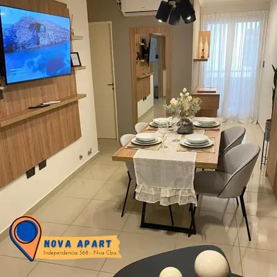 a dining room table with chairs and a tv on a wall at Nova Apartament in Cordoba