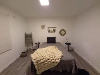 a bedroom with a bed with a blanket on it at Finlay Departamento in Villa Carlos Paz