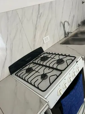 a white stove top oven in a kitchen at Depto 3 in Río Cuarto