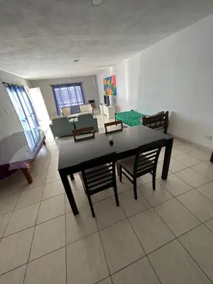 a living room with a black table and chairs at Depto 3 in Río Cuarto