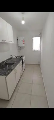 a kitchen with white cabinets and a window at Departamento in Cordoba