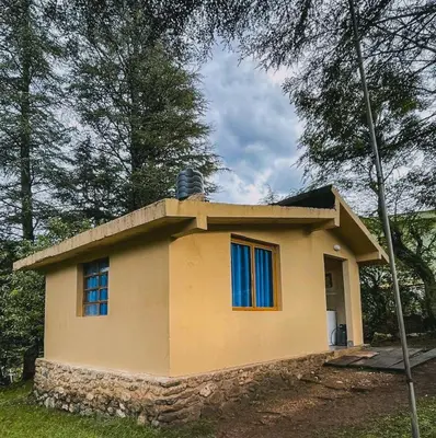 a small house with blue windows on top of it at Cabaña La Resolana in Villa Alpina
