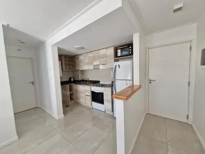 a kitchen with white cabinets and a white refrigerator at Bonito departamento in Cordoba