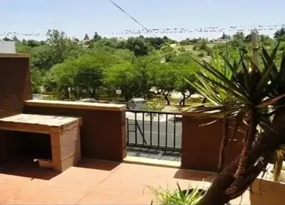 a balcony with a view of a park at Departamentos Luluara in Villa Carlos Paz