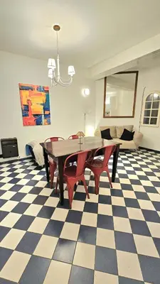 a dining room with a table and chairs on a checkered floor at Crin Blanca in Cordoba